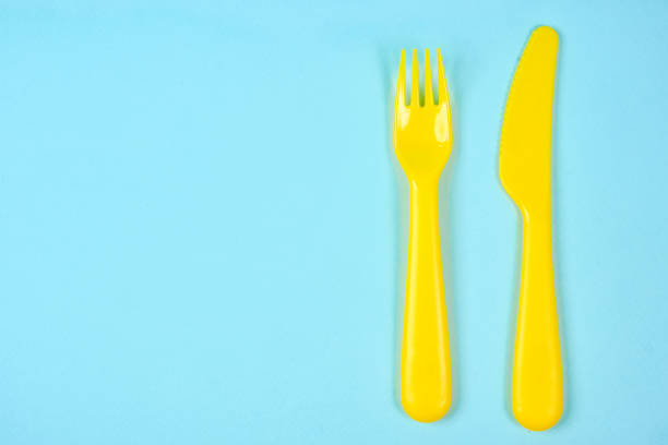 istock Multicolored plastic dishes on a blue background. The concept of environmental pollution by plastic, ecolog place for text, flat lay 1225052473