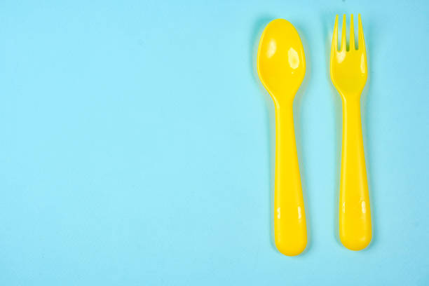 istock Multicolored plastic dishes on a blue background. The concept of environmental pollution by plastic, ecolog place for text, flat lay 1225052493