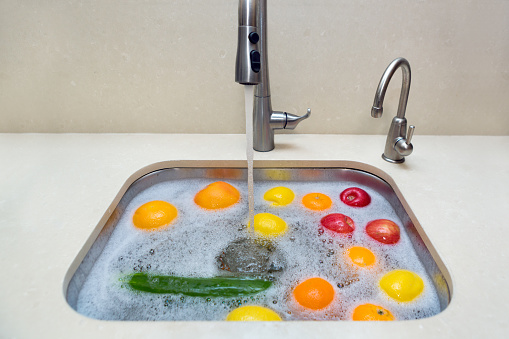 Washing fruits and vegetables with soap and water to protect against the coronavirus.
