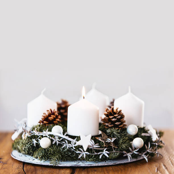 istock Lighting the first candle on the Advent Christmas Wreath. 1225054219