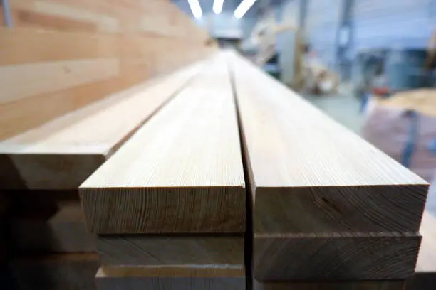 Photo of Glued pine timber beams for wooden windows closeup view, selective focus