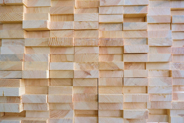 istock Stack of three-layer wooden glued laminated timber beams from pine finger joint spliced boards 1225055508