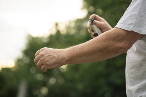 istock Senior man hands spraying mosquito / insect repellent in the forest 1225057928