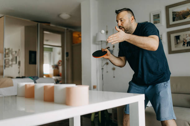 istock Mid adult man plays ping pong 1225057953