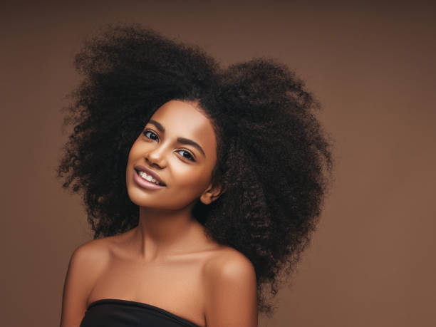 istock Beautiful smiling girl with curly hairstyle 1225058074
