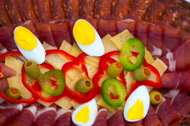 Close up of small canapes arranged on a plate over light background - selective focus