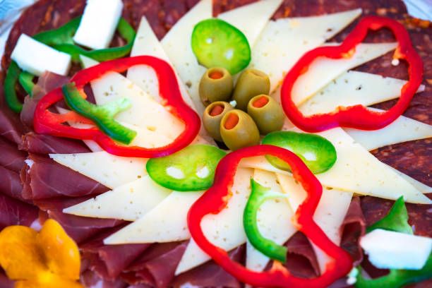 Traditional Appetizer Savory Dish Meze for wedding celebration, Croatia from cheese, sausages and green peppers.