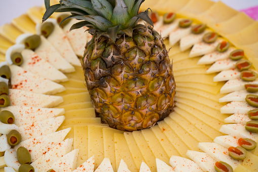 Traditional Appetizer pineapple Meze for wedding celebration, from different cheese and olives, Croatia.