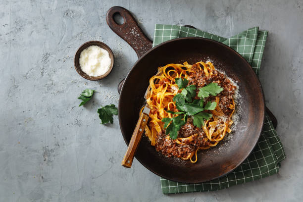 Classic Tagliatelle with Sauce Bolognese Classic Tagliatelle with Sauce Bolognese. Flat lay top-down composition on concrete background sauce photos stock pictures, royalty-free photos & images