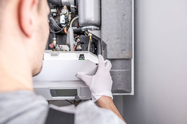 Contractor Repairing Central Heating Furnace System. Close Up Of Caucasian Service Worker Fixing Central Heating Furnace System. furnace photos stock pictures, royalty-free photos & images