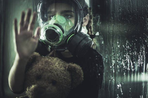istock Child Wearing Gas Mask Looking Out Window. 1225060748