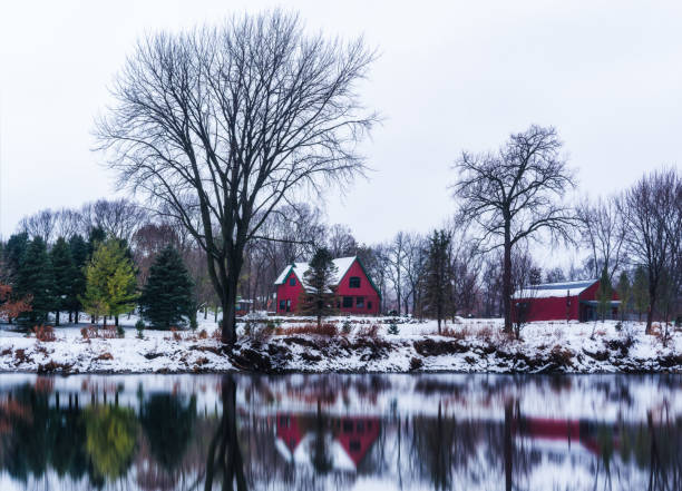 istock red barn house reflection in the snow 1225061953
