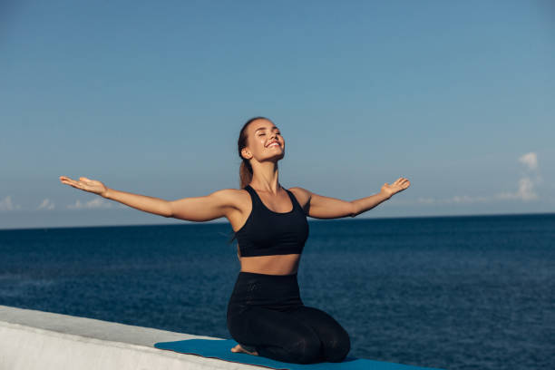 istock Young woman meditating outdoors 1225062017
