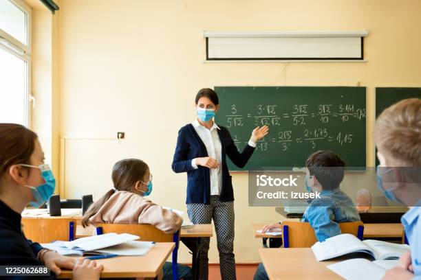 Covid19 A Teacher Teaches Mathematics Stock Photo - Download Image Now - Teacher, Education, School Building