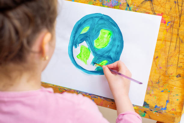istock Little girl is drawing earth. 1225063001