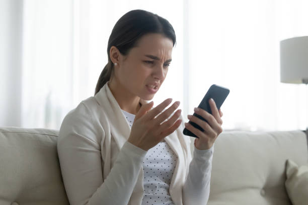 istock Unhappy young woman frustrated by cellphone problem 1225064106