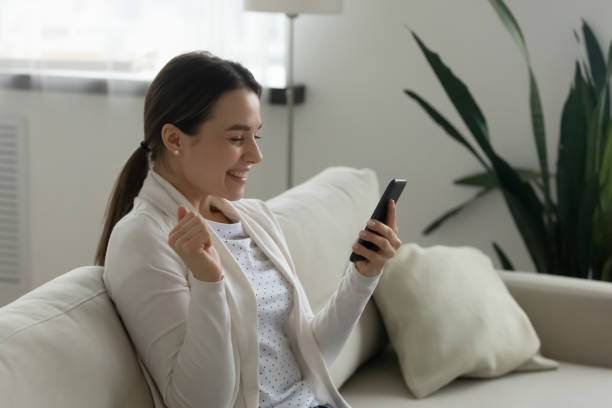 istock Excited young woman triumph get good cell message 1225064111