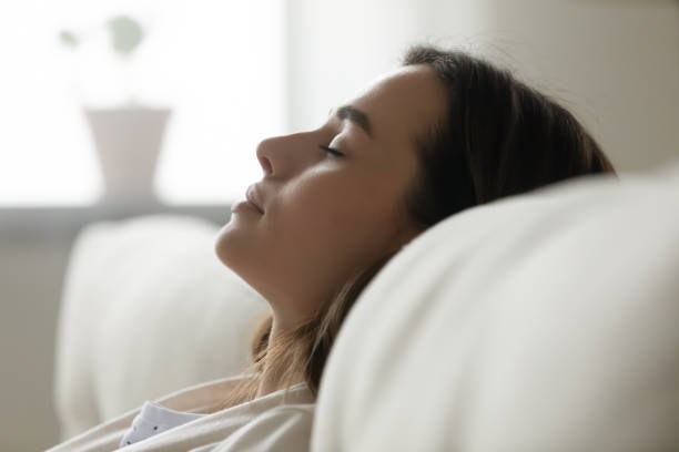 istock Close up of peaceful young woman sleeping on sofa 1225064116