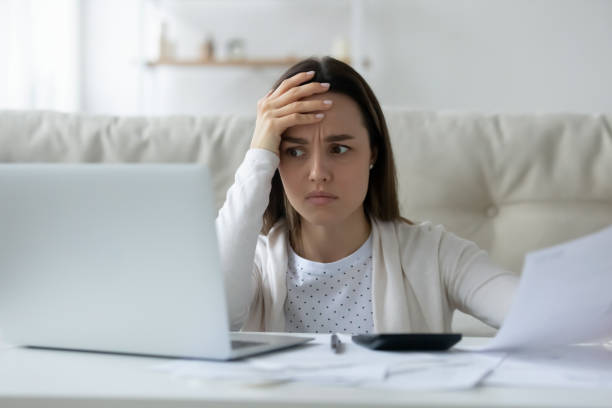 istock Confused young woman have problems paying bills online 1225064132