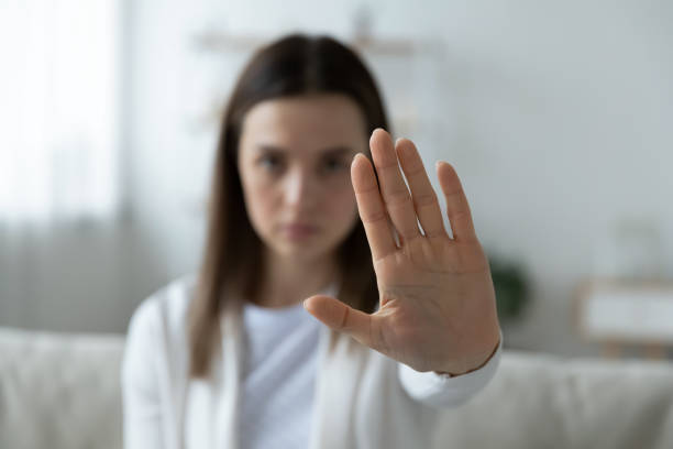 Young woman show stop gesture demonstrate protest Close up of young woman show stop gesture sign by hand saying no to domestic violence or abuse, determined millennial female protest against abortion or discrimination, nonverbal language concept refusing photos stock pictures, royalty-free photos & images