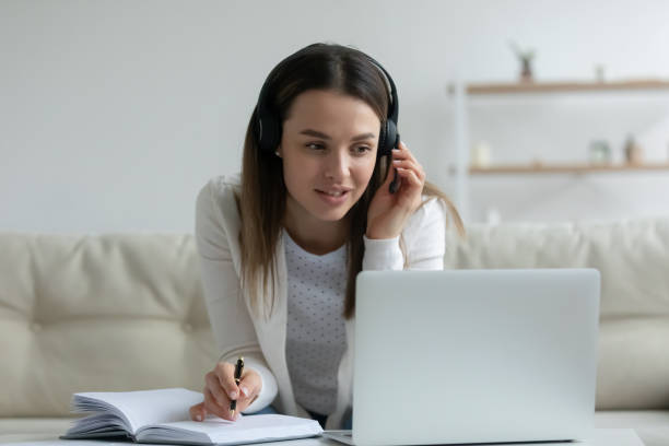 istock Millennial girl make notes studying on laptop at home 1225064270