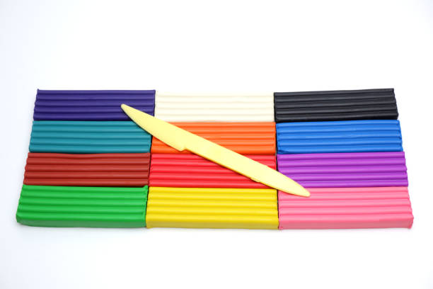 istock Bright multi-colored plasticine sticks and sculptural knife on white background. Colorful plastic polymer clay set. 1225065501