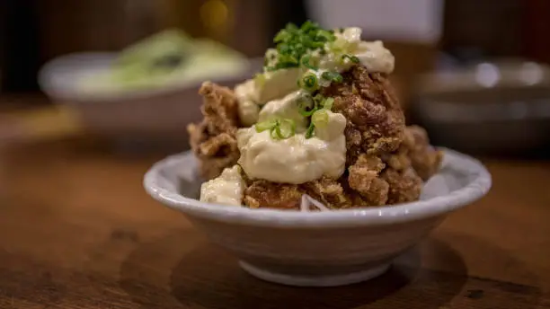 Chicken Karaage with mayonnaise is a Japanese cooking technique of deep fried. Small pieces of the meat with flour and frying in a oil.