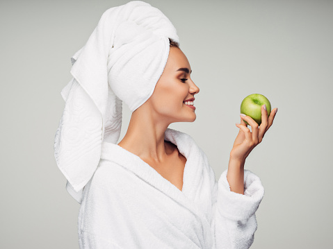 Woman holds green fresh apple