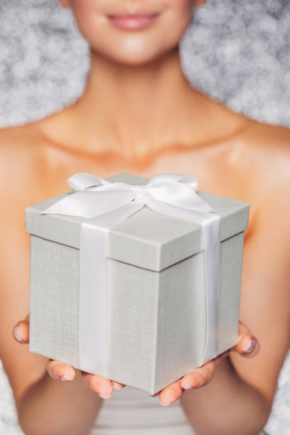 Happy woman with a gift Happy woman with a gift beautiful women giving head stock pictures, royalty-free photos & images