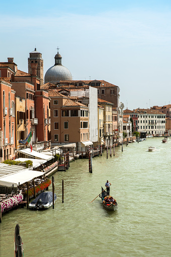 Venice, Italy - JUL 01, 2018: The view of Grand canal with gondola from Ponte degli Scalzi in summer day