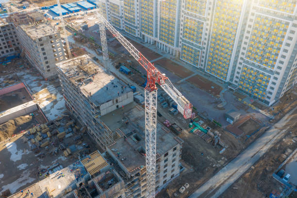 istock Aerial view of construction cranes and a multi-storey building under construction in a residential area of the city. 1225070889