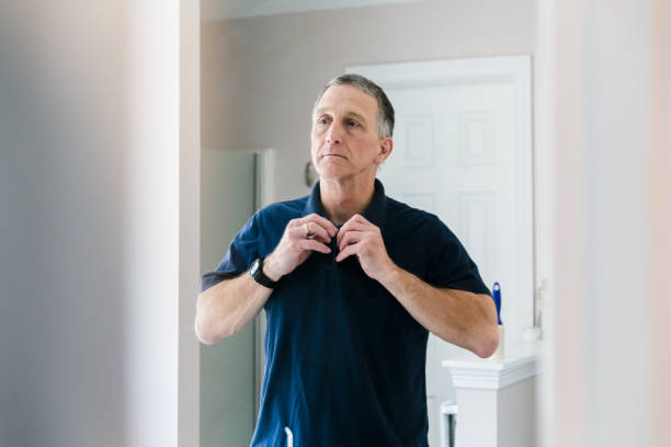 In morning, mature man prepares for his work day