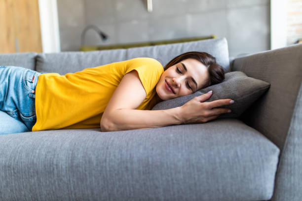 istock Young sleeping woman is lying on a pillow on a couch 1225072170