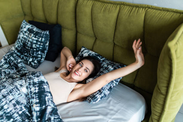 istock Young woman waking in the morning up fully rested. 1225072736