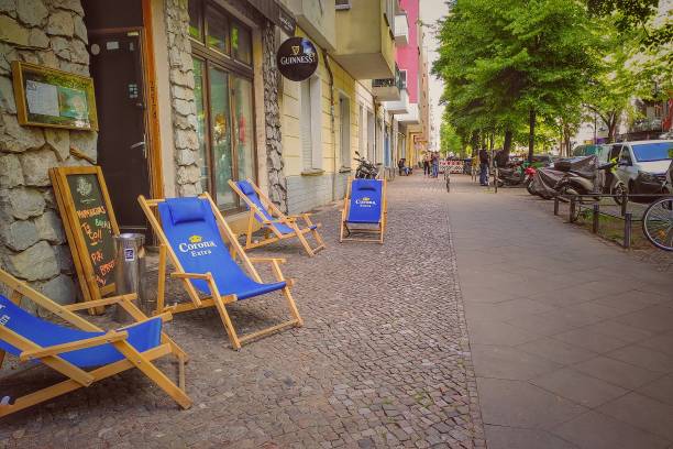 Reopened Berlin street restaurant after restrictions lift during coronavirus shutdown in Germany Berlin, Germany - May 15, 2020: Street with garden chairs from a reopened pub after social distancing regulations were lessened following the shutdown during the coronavirus crisis in Germany. friedrichshain photos stock pictures, royalty-free photos & images