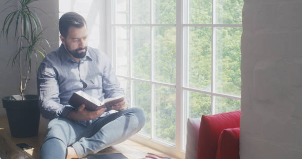 istock Man reading the Bible at home 1225079083