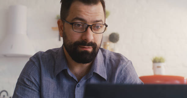 istock Man having a video call in the kitchen 1225079109