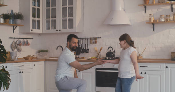 istock Father and daughter dancing in the kitchen 1225079309