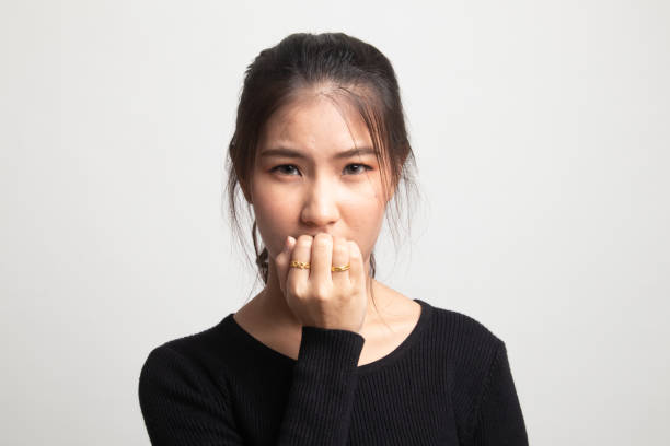 istock Unsure hesitant nervous young asian  woman biting her fingernails. 1225084616