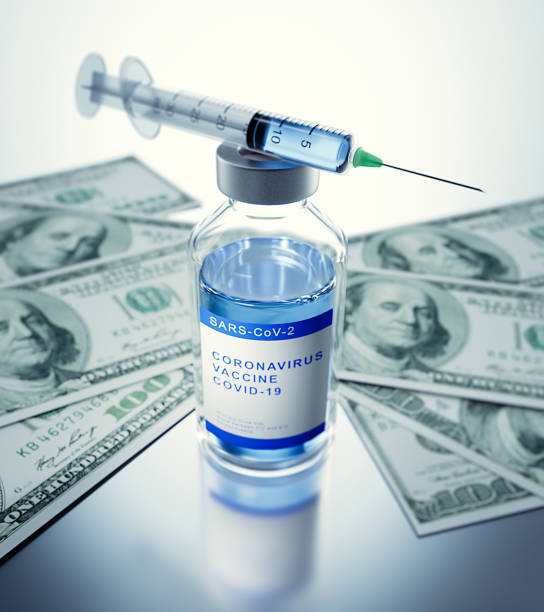 istock Syringe and Vaccine with Money 1225087108