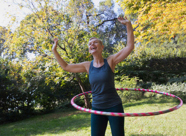 istock Mature woman using a plastic hoop at the park 1225088001
