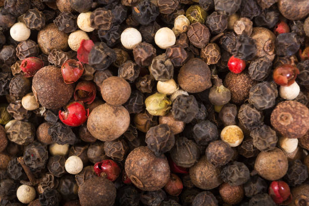 istock Black, red and white pepper grains as background close up. Spice. 1225089533