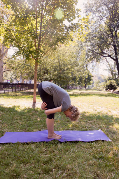 istock Mature woman exercising outside at the park using mat 1225090194