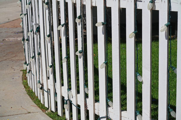 istock White Fence with Decorative String of Lights 1225090234