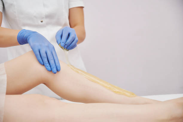 istock the procedure shugaring. master in blue medical gloves apply sugar paste with his hands 1225091426