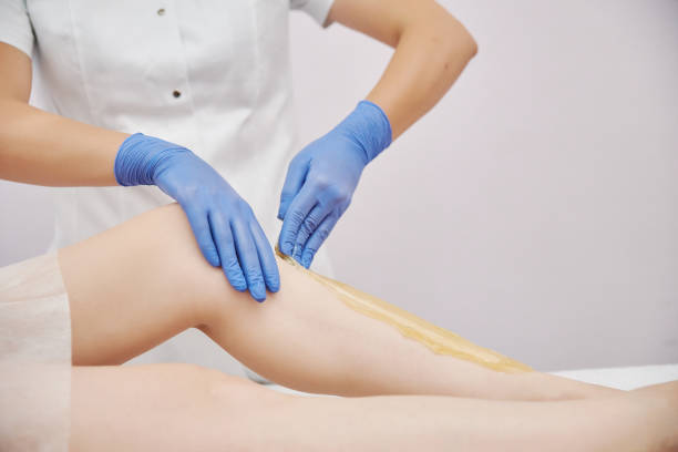 istock the procedure shugaring. master in blue medical gloves apply sugar paste with his hands 1225091430