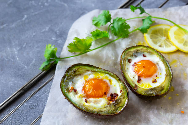 istock baked egg in avocado Boats. Copy space 1225091665