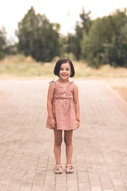 istock Kid girl walking in park 1225092548