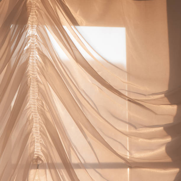 istock Elegant, thin transparent curtain on the window, by sunlight. Selective soft focus. 1225092680
