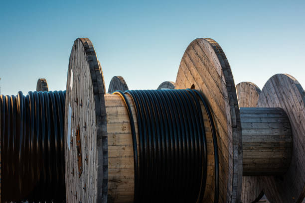 Black cable on large wooden drums Black cable on large wooden drums. spool photos stock pictures, royalty-free photos & images